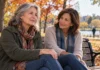Deux femmes assises sur un banc, illustrant le soutien social face à un inconfort au genou.