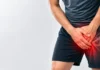 Person holding the groin with a stylized overlay of the hip region