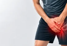 Person holding the groin with a stylized overlay of the hip region