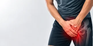 Person holding the groin with a stylized overlay of the hip region